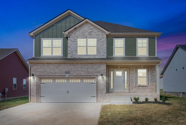 view of front of home with an attached garage, concrete driveway, brick siding, board and batten siding, and a front yard