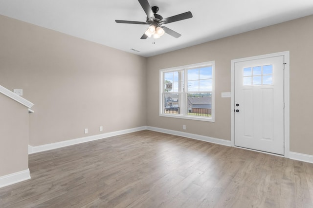 foyer with wood finished floors, ceiling fan, and baseboards