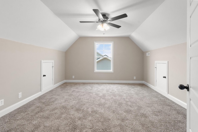 bonus room featuring carpet, lofted ceiling, ceiling fan, and baseboards