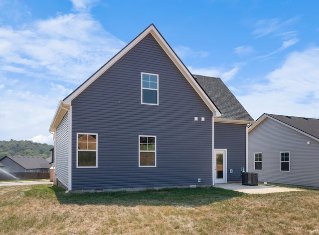 back of house featuring cooling unit, a patio, a lawn, and crawl space