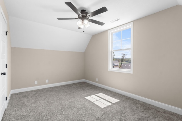 bonus room featuring lofted ceiling, carpet, a ceiling fan, and baseboards