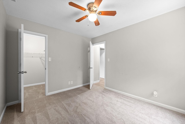 938 Merritt Lewis Ln, Clarksville, TN 37042 - unfurnished bedroom featuring carpet flooring, a walk in closet, baseboards, a closet, and a ceiling fan