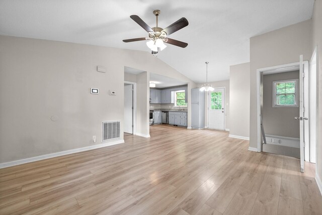 938 Merritt Lewis Ln, Clarksville, TN 37042 - unfurnished living room with ceiling fan, light wood-type flooring, vaulted ceiling, baseboards, and a chandelier