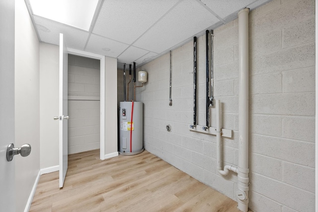 938 Merritt Lewis Ln, Clarksville, TN 37042 - finished below grade area with water heater, wood finished floors, a paneled ceiling, baseboards, and concrete block wall
