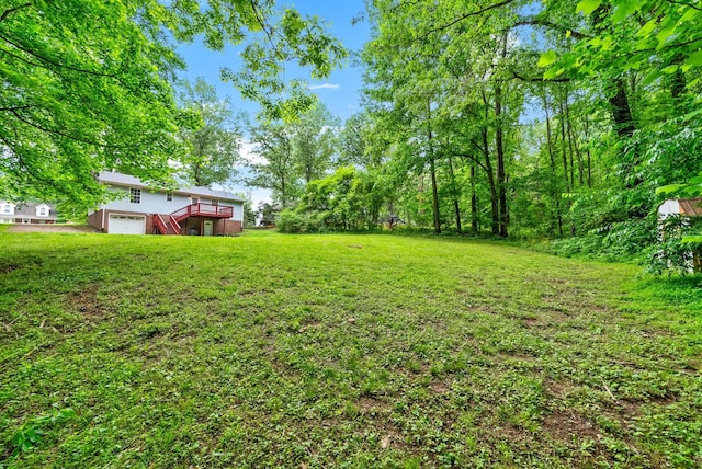938 Merritt Lewis Ln, Clarksville, TN 37042 - view of grassy yard featuring a deck, an attached garage, and stairway