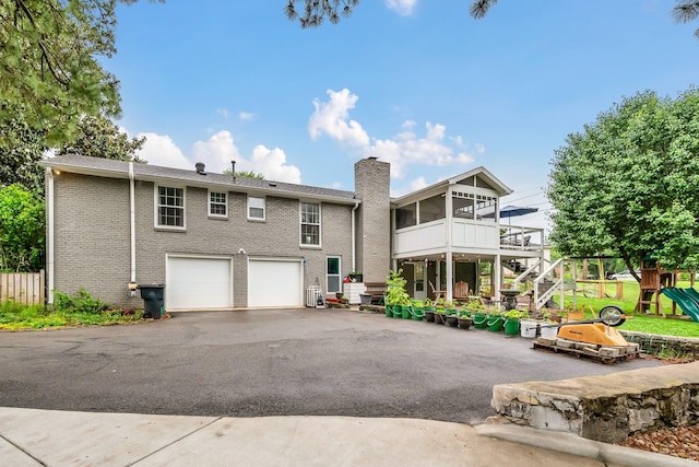 1033 Percy Warner Blvd, Nashville, TN 37205 - back of property with driveway, an attached garage, a playground, a chimney, and stairway
