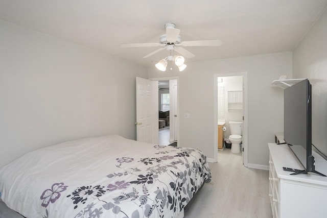 1543 James Gafford Dr, La Vergne, TN 37086 - bedroom with light wood finished floors, baseboards, ceiling fan, and ensuite bath
