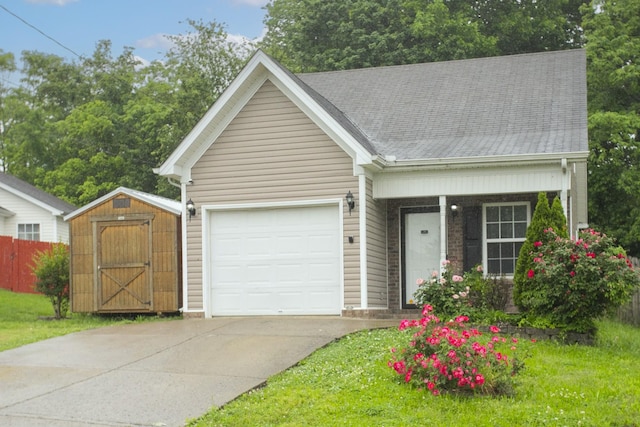 1543 James Gafford Dr, La Vergne, TN 37086 - view of front of house with a shed, a garage, concrete driveway, fence, and a shingled roof
