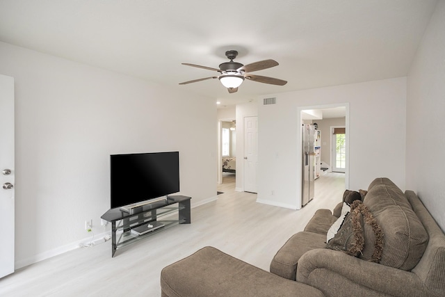 1543 James Gafford Dr, La Vergne, TN 37086 - living room with light wood-type flooring, a ceiling fan, and baseboards