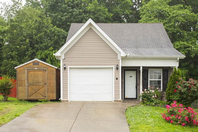 1543 James Gafford Dr, La Vergne, TN 37086 - view of front facade with a storage shed, concrete driveway, a garage, and an outdoor structure