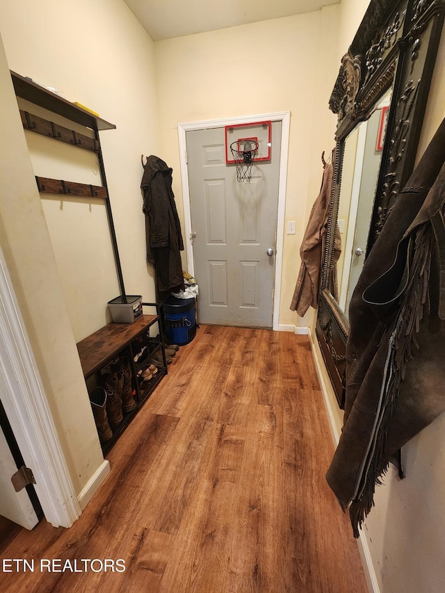 mudroom featuring wood finished floors and baseboards