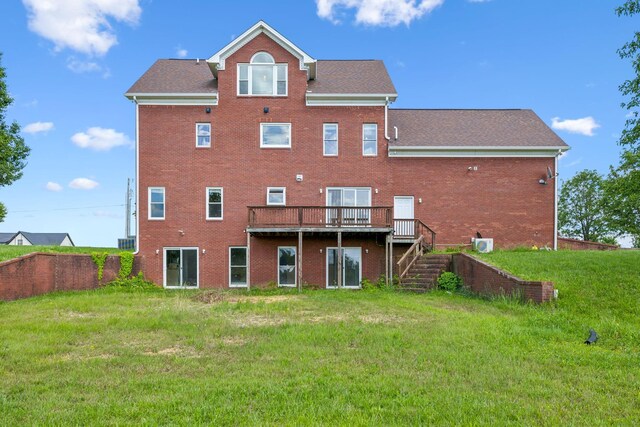 122 Windcrest Dr, Hohenwald, TN 38462 - back of property featuring brick siding, a deck, stairway, and a yard