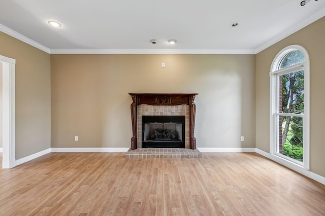 122 Windcrest Dr, Hohenwald, TN 38462 - unfurnished living room featuring crown molding, light wood-style floors, baseboards, a fireplace with raised hearth, and recessed lighting