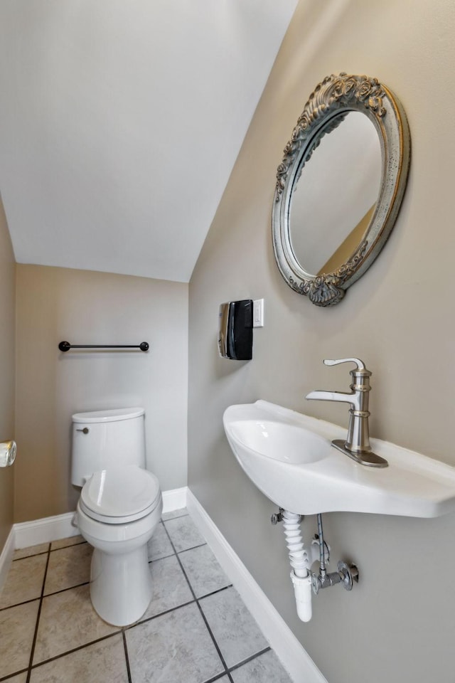 122 Windcrest Dr, Hohenwald, TN 38462 - half bathroom featuring toilet, vaulted ceiling, tile patterned floors, and baseboards