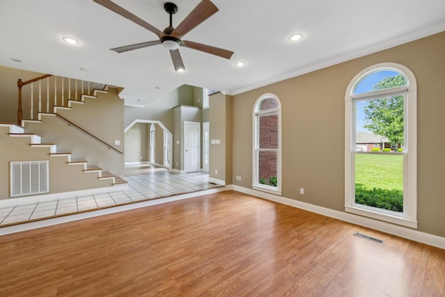 122 Windcrest Dr, Hohenwald, TN 38462 - unfurnished living room featuring wood finished floors, ceiling fan, crown molding, baseboards, and stairs