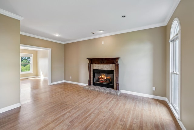 122 Windcrest Dr, Hohenwald, TN 38462 - unfurnished living room featuring a tile fireplace, light wood-style flooring, crown molding, baseboards, and recessed lighting