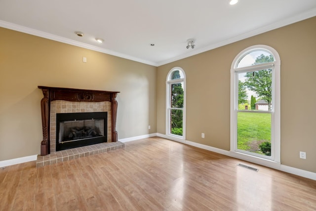 122 Windcrest Dr, Hohenwald, TN 38462 - unfurnished living room featuring wood finished floors, a tile fireplace, crown molding, and baseboards