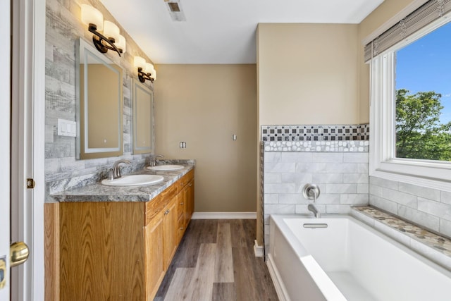 122 Windcrest Dr, Hohenwald, TN 38462 - bathroom featuring wood finished floors, plenty of natural light, baseboards, and a bath