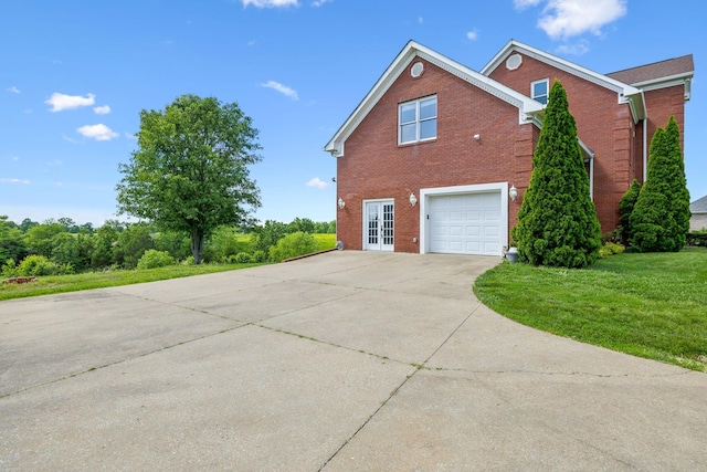 122 Windcrest Dr, Hohenwald, TN 38462 - view of property exterior featuring brick siding, driveway, a garage, and a lawn