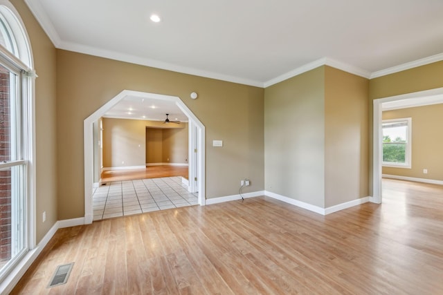 122 Windcrest Dr, Hohenwald, TN 38462 - unfurnished room with light wood-style flooring, crown molding, baseboards, a ceiling fan, and arched walkways