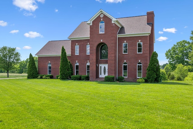 122 Windcrest Dr, Hohenwald, TN 38462 - view of front of property featuring a chimney, a front lawn, and brick siding