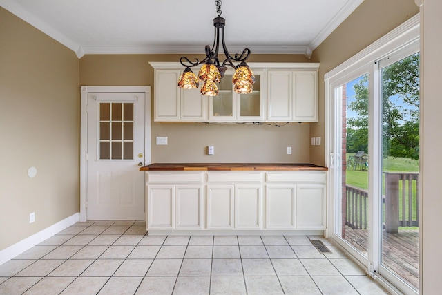 122 Windcrest Dr, Hohenwald, TN 38462 - kitchen featuring light tile patterned floors, butcher block countertops, ornamental molding, decorative light fixtures, and white cabinetry