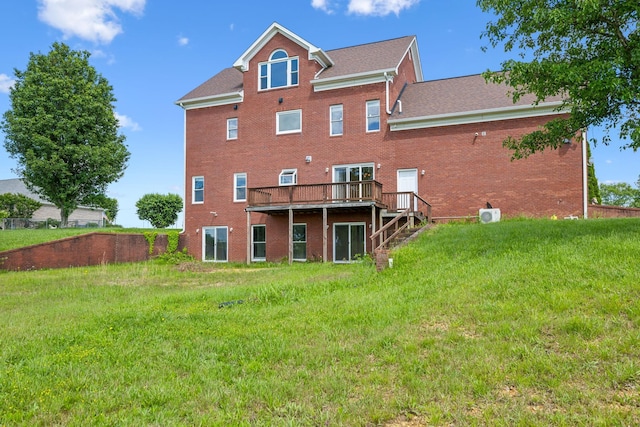 122 Windcrest Dr, Hohenwald, TN 38462 - rear view of house featuring brick siding, a deck, a lawn, and roof with shingles