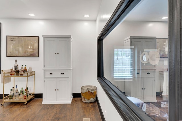 corridor with wood finished floors and recessed lighting
