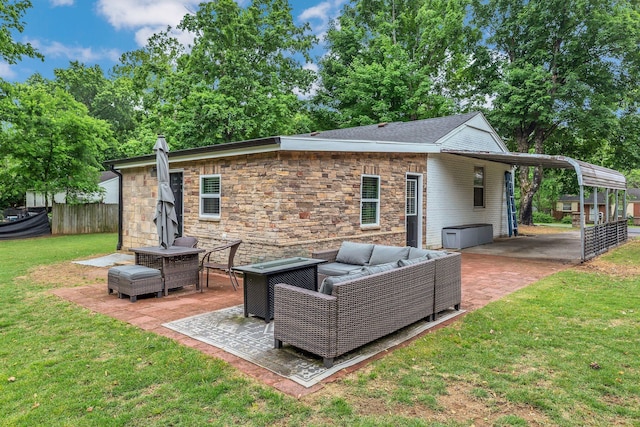 back of property with an outdoor hangout area, stone siding, and a carport