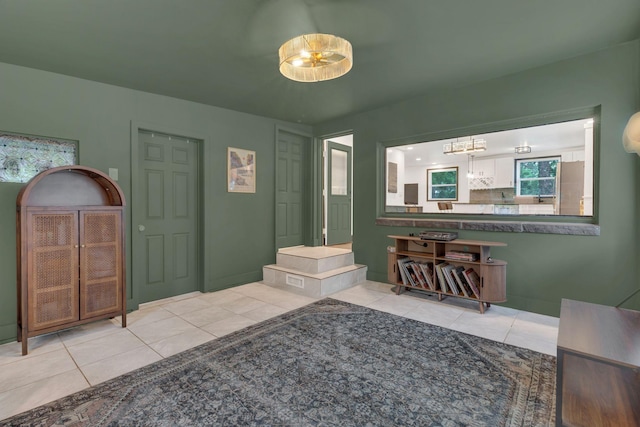 bathroom with tile patterned floors and a chandelier