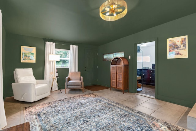 sitting room featuring tile patterned floors and vaulted ceiling