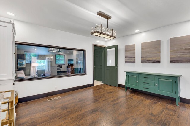 foyer entrance with dark wood finished floors, recessed lighting, and baseboards