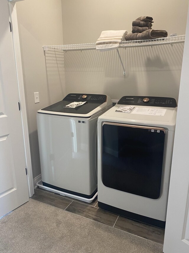 laundry room with separate washer and dryer and tile patterned flooring