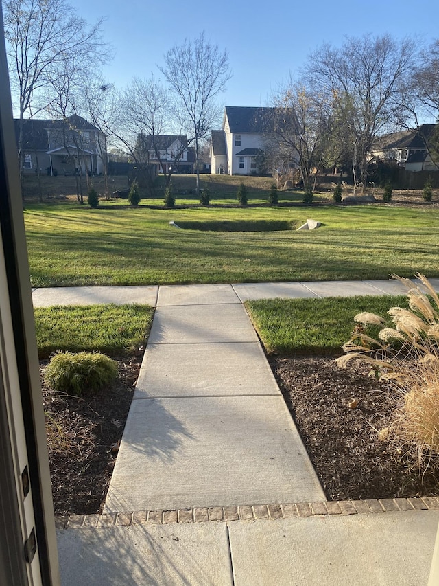 view of community with a residential view and a lawn