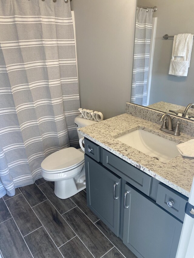 bathroom featuring toilet and vanity