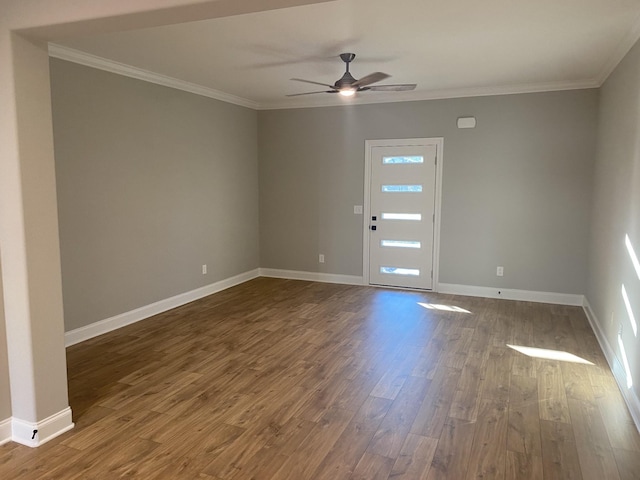 foyer entrance featuring ceiling fan, dark wood finished floors, ornamental molding, and baseboards