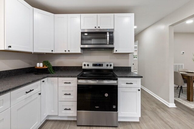400 Log Wall Rd, Dickson, TN 37055 - kitchen with appliances with stainless steel finishes, light wood-style flooring, white cabinets, baseboards, and dark countertops