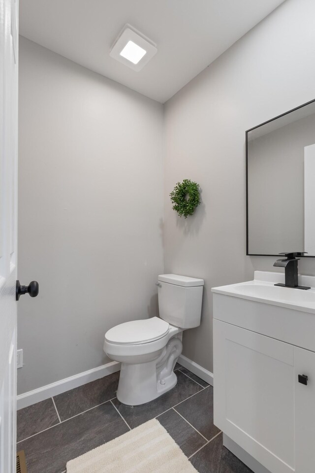 400 Log Wall Rd, Dickson, TN 37055 - half bathroom featuring toilet, tile patterned flooring, vanity, and baseboards