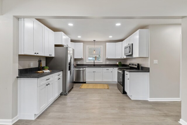 400 Log Wall Rd, Dickson, TN 37055 - kitchen featuring stainless steel appliances, a sink, light wood-type flooring, white cabinets, and recessed lighting