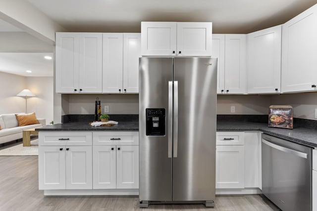 400 Log Wall Rd, Dickson, TN 37055 - kitchen featuring stainless steel appliances, light wood-style floors, white cabinetry, dark countertops, and recessed lighting