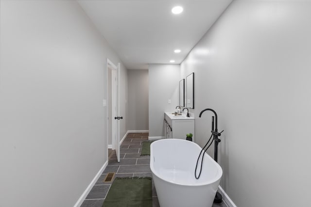 400 Log Wall Rd, Dickson, TN 37055 - bathroom with a freestanding bath, vanity, recessed lighting, and baseboards