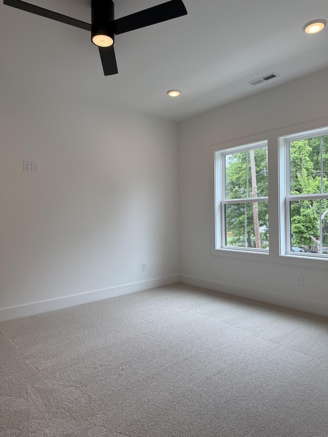 empty room featuring carpet, baseboards, recessed lighting, and a ceiling fan