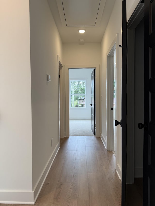 hall with wood finished floors, baseboards, and recessed lighting