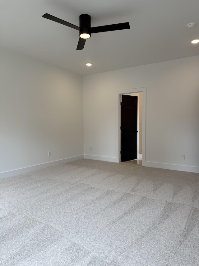 spare room featuring light colored carpet, ceiling fan, baseboards, recessed lighting, and a smoke detector
