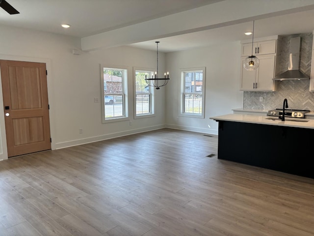 127 Cleveland St, Nashville, TN 37207 - kitchen with wall chimney range hood, light countertops, a chandelier, tasteful backsplash, and recessed lighting