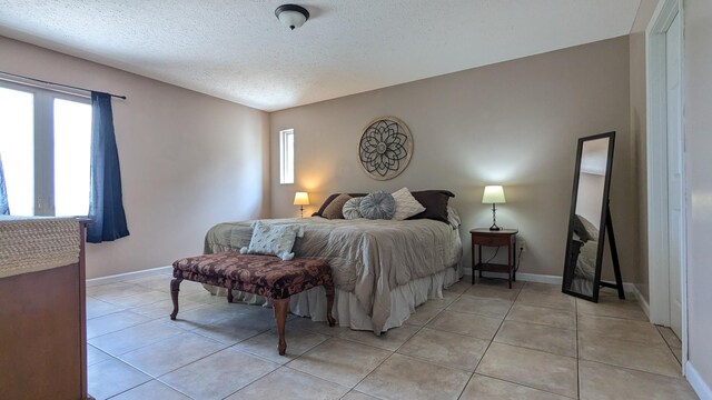460 Mate Allen Rd, Gainesboro, TN 38562 - bedroom with a textured ceiling, baseboards, and light tile patterned floors