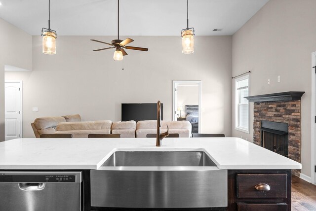 805 Waldon Ct, Clarksville, TN 37042 - kitchen featuring dishwasher, open floor plan, a sink, a stone fireplace, and light countertops