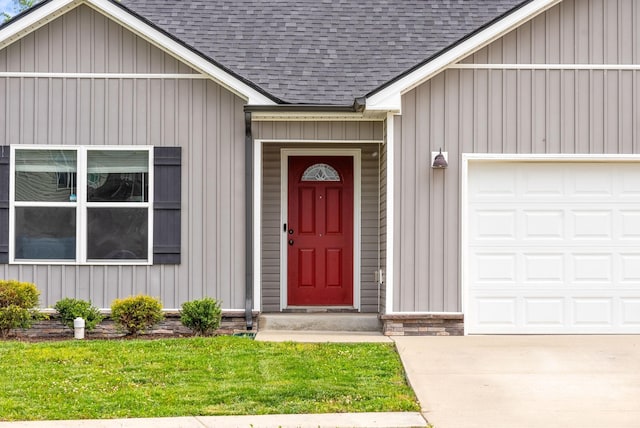 805 Waldon Ct, Clarksville, TN 37042 - doorway to property featuring roof with shingles, an attached garage, board and batten siding, and a yard