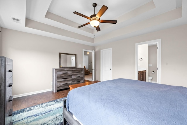 805 Waldon Ct, Clarksville, TN 37042 - bedroom featuring a tray ceiling, wood finished floors, baseboards, ensuite bath, and a ceiling fan