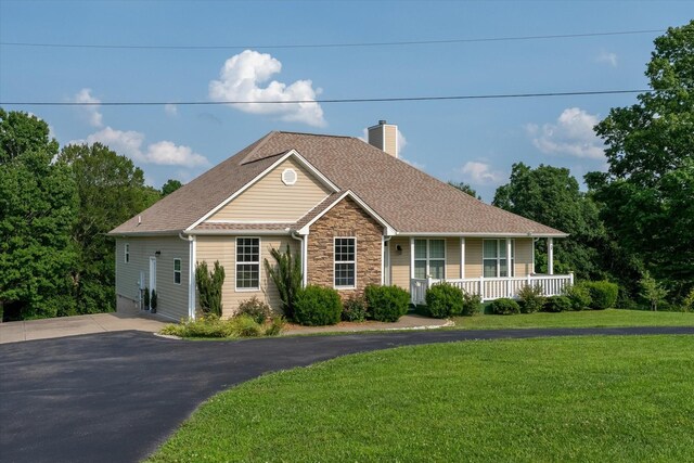 3337 Tarsus Rd, Palmyra, TN 37142 - view of front of home featuring a porch, stone siding, a chimney, a front yard, and roof with shingles